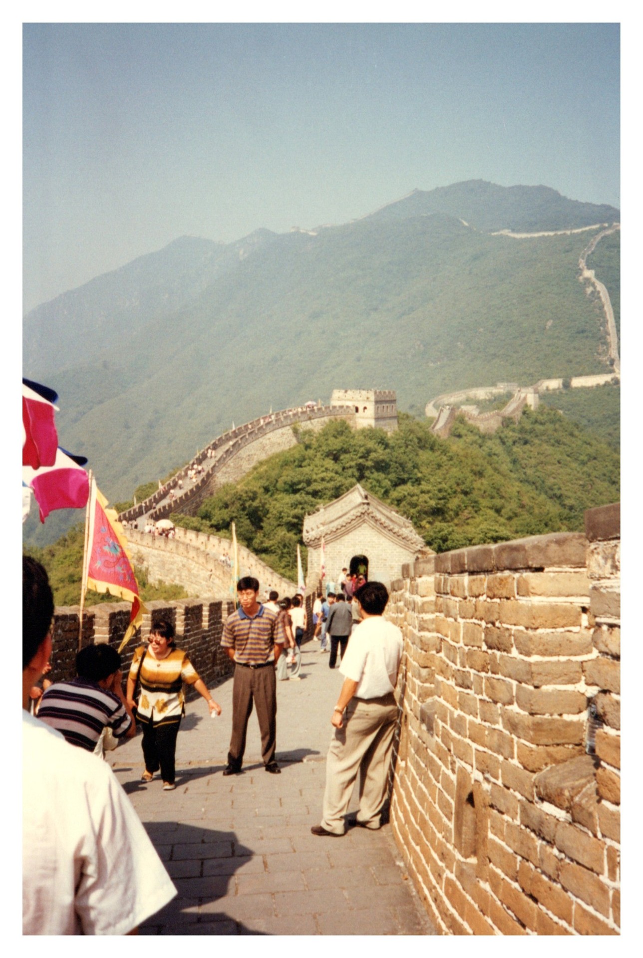 The Great Wall of China winding through forested hills